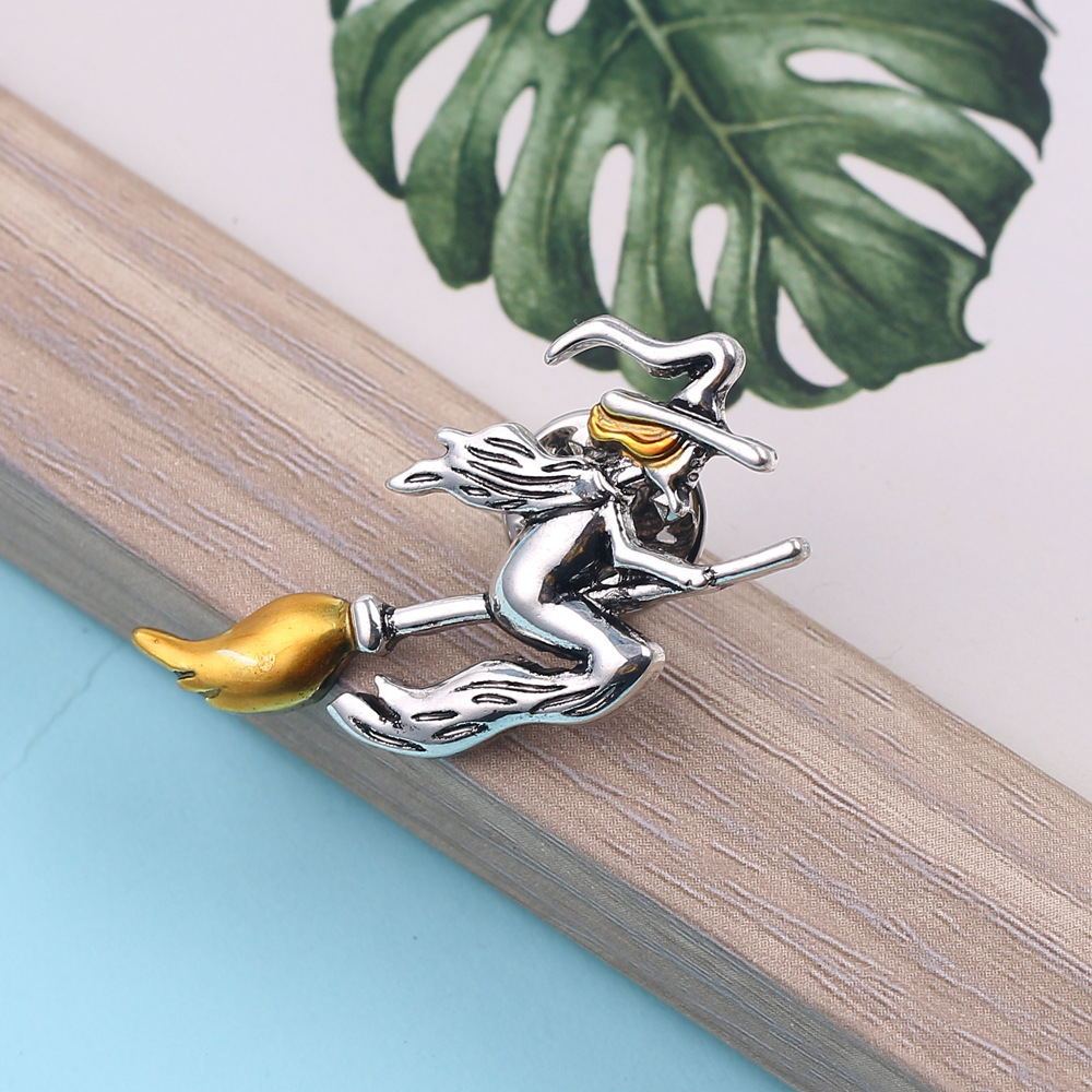 Retro witch riding broomstick brooch