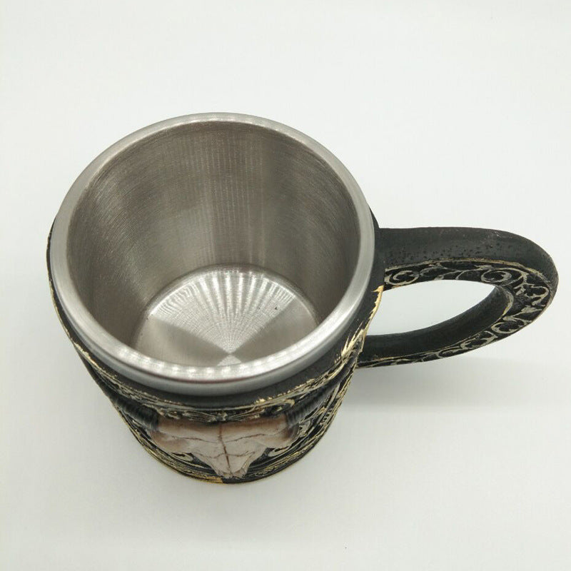 Carved resin skull and sheep head cup