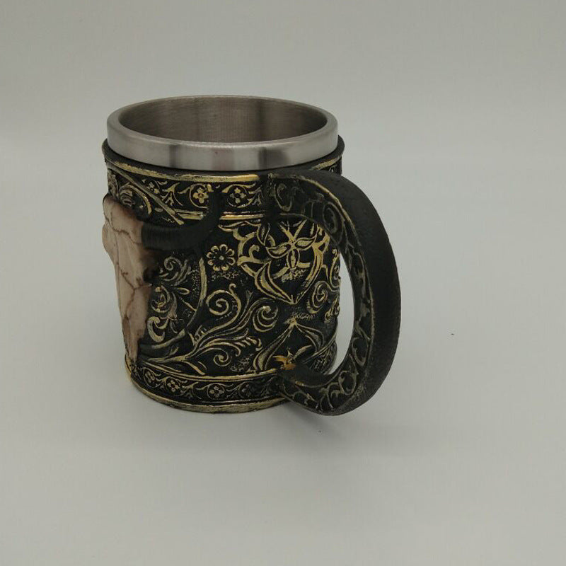 Carved resin skull and sheep head cup