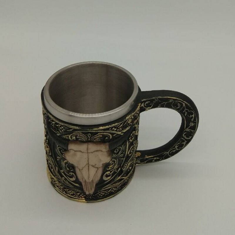 Carved resin skull and sheep head cup